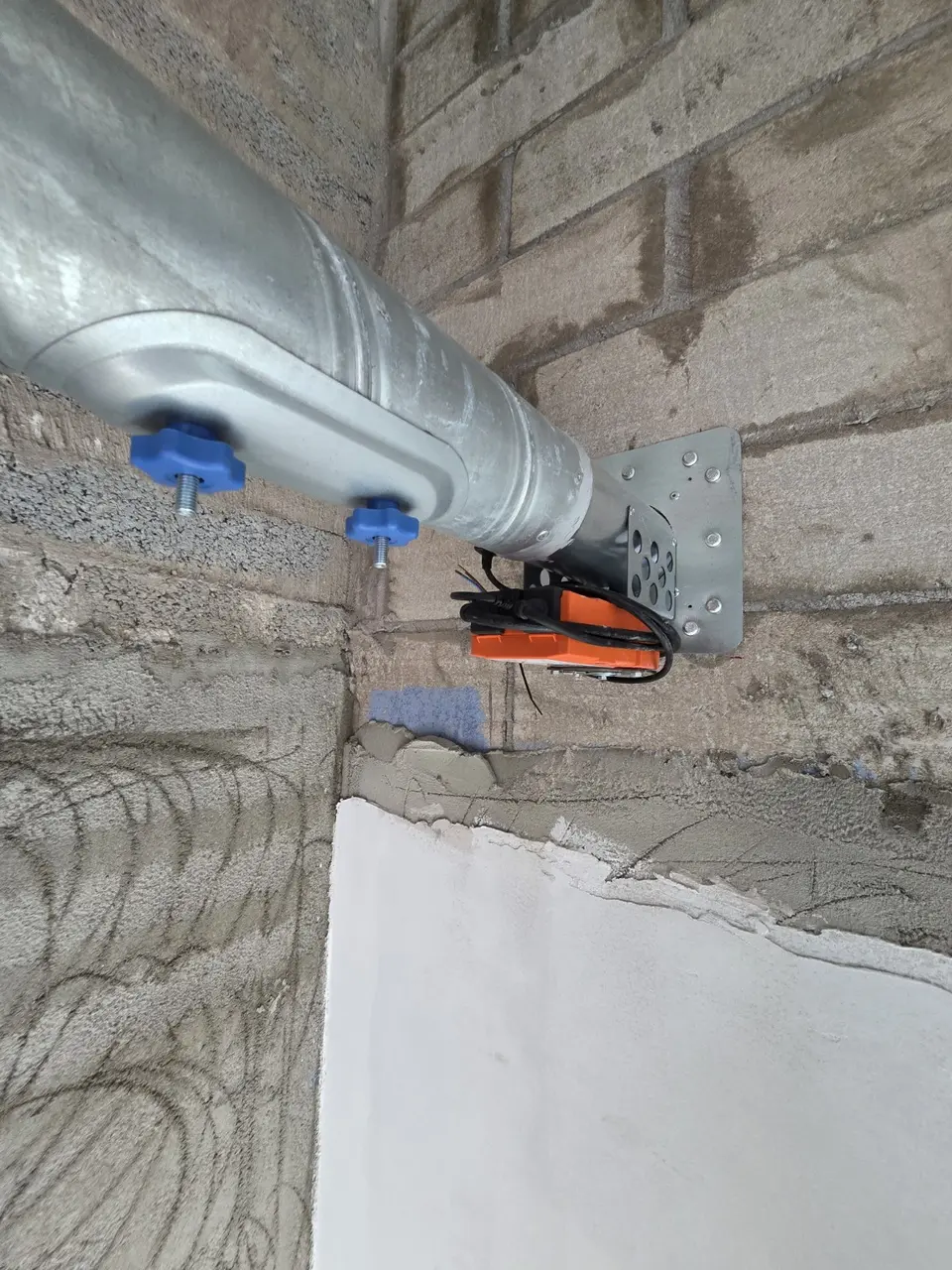 Round fire damper installation in masonry on site